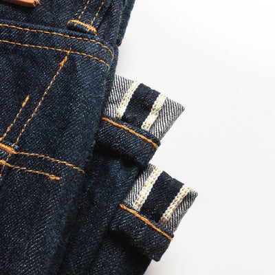 An up close image of the gold selvedge detail on the jeans.