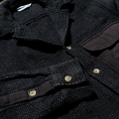 A detailed look at a highly textured black shirt.