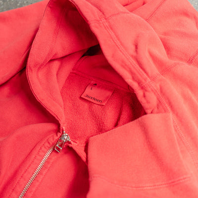 A close up shot of a red zip hoody.