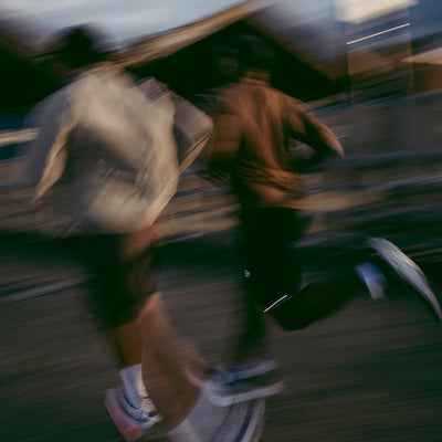 A speed blurred image of two men running.