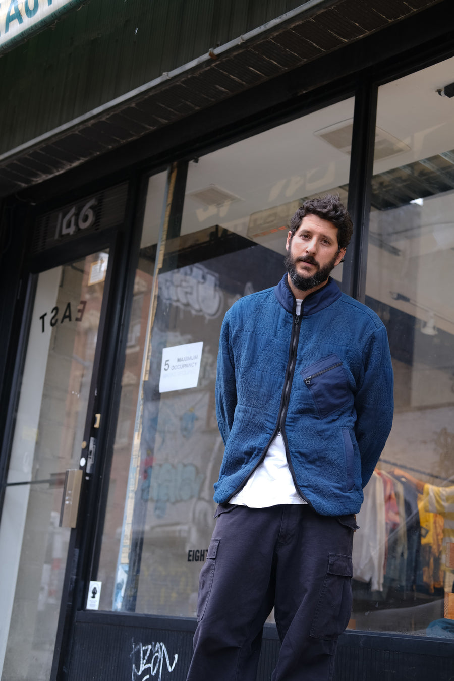 Antonio wearing the jacket in front of his store.