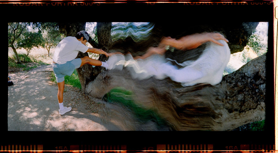 A wavy film photo of a runner stretching.