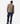 Person wearing a leopard print jacket and blue jeans on a white background