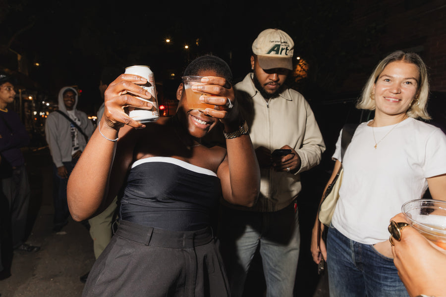 Someone outside dancing with drinks in hand