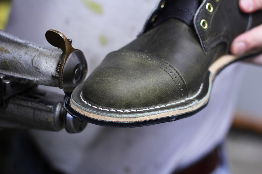 Machines stitch down dainite soles onto the boots.