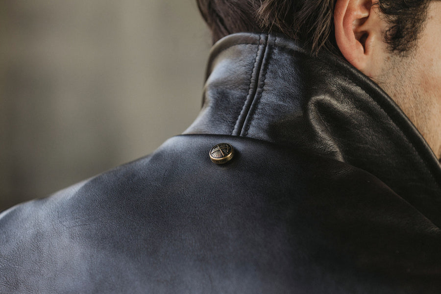 Detail shot of the 15 year snap and collar on a leather jacket.