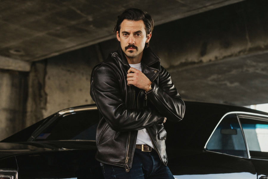 Model posing with a leather jacket.