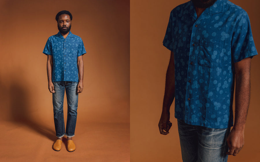 A man in a blue shirt and jeans.