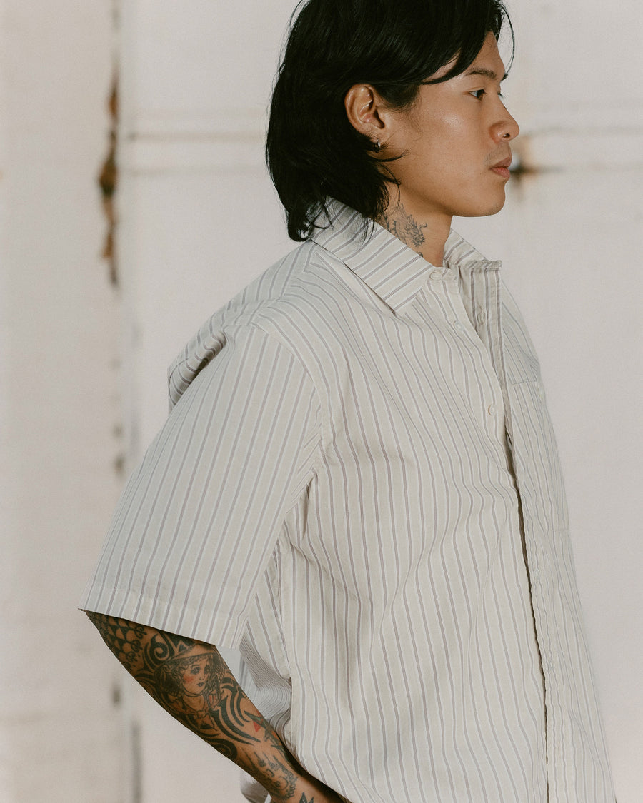 A close up shot of a boxy short sleeve striped poplin shirt.