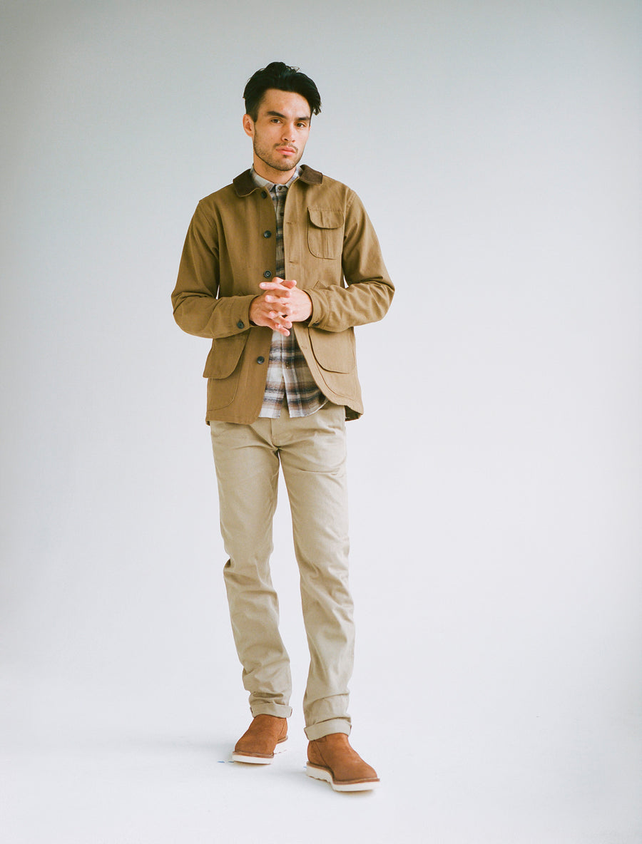 Model wearing tan jacket, tan flannel and tan chinos.