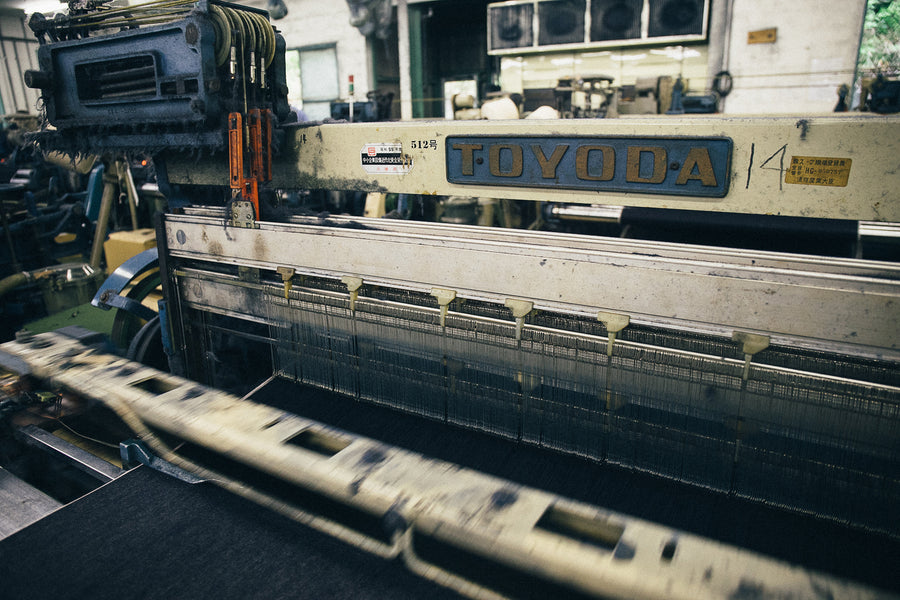 A Toyoda selvedge denim loom weaves selvedge denim.