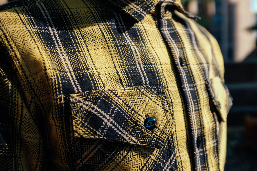Another up close look at the yellow flannel, this time in landscape and a clearer view of the shiny black metal buttons.