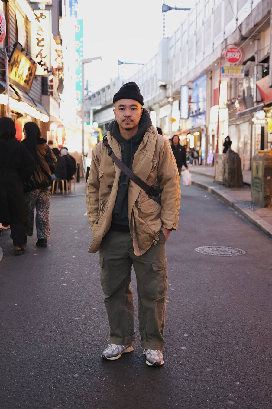 A man stands on a busy street in Japan