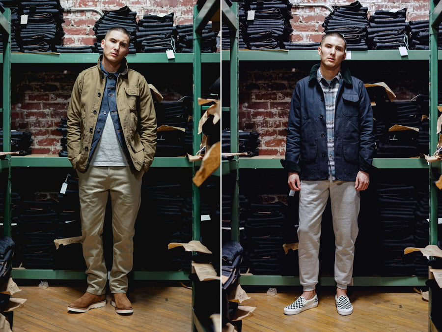 The model wears the 3sixteen Hunting Jacket over a denim jacket and paired with sweatpants.