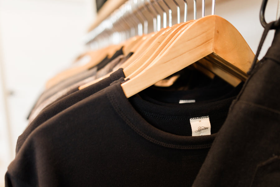 Close up view of sweater hanging on rack.