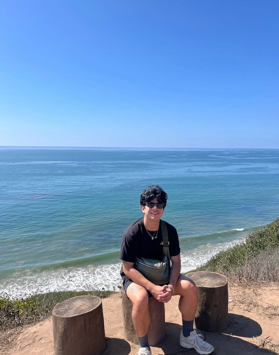 A man sitting by the water.