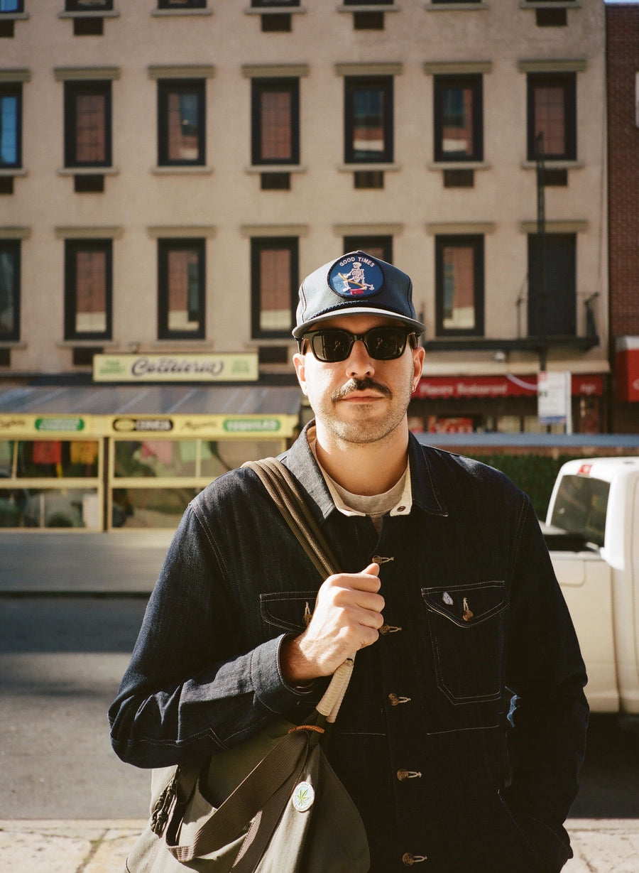 A cool guy on the street in sunglasses.