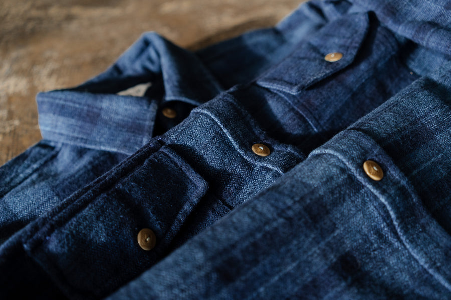A detailed look at a blue flannel's texture.