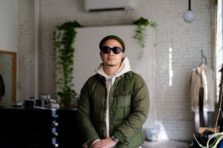 A man in sunglasses and an olive jacket stands in our LA store.