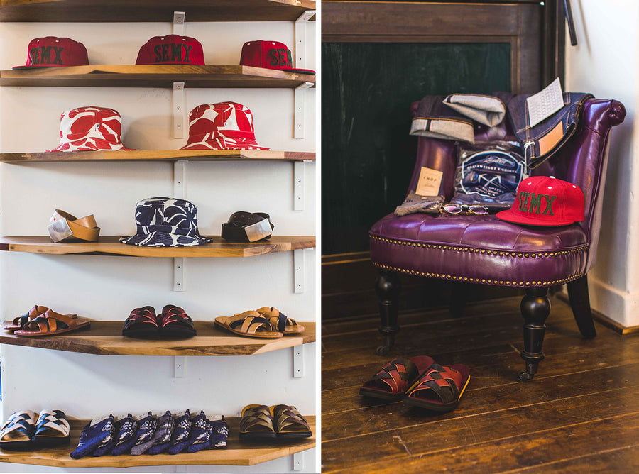 Shelf with various headwear and footwear on display.