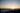 The sun dips across the horizon over the Pacific Ocean.