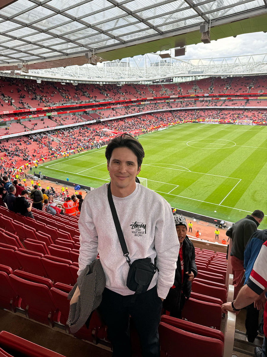 A man stands in a football stadium.