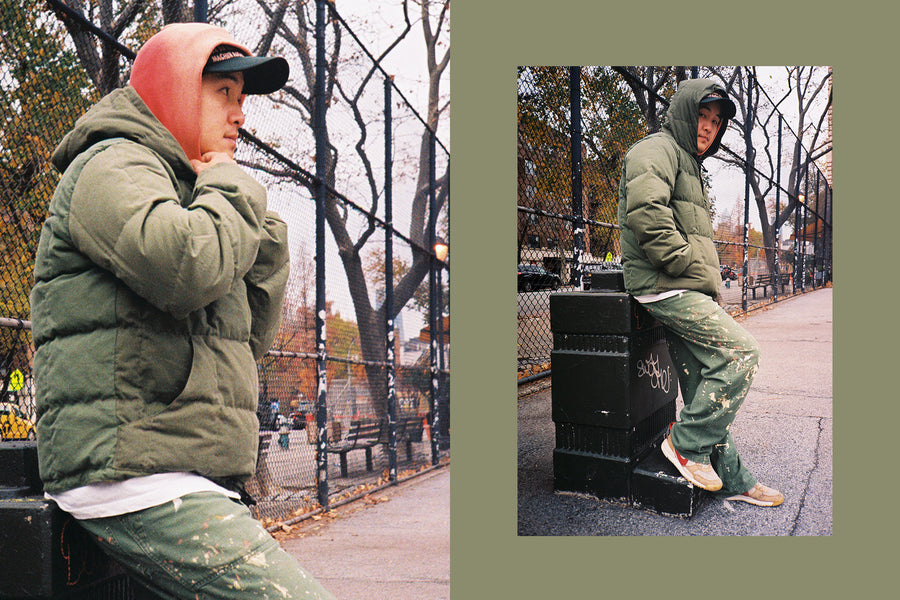 A young man pulls a hood over his head in the cold winter.