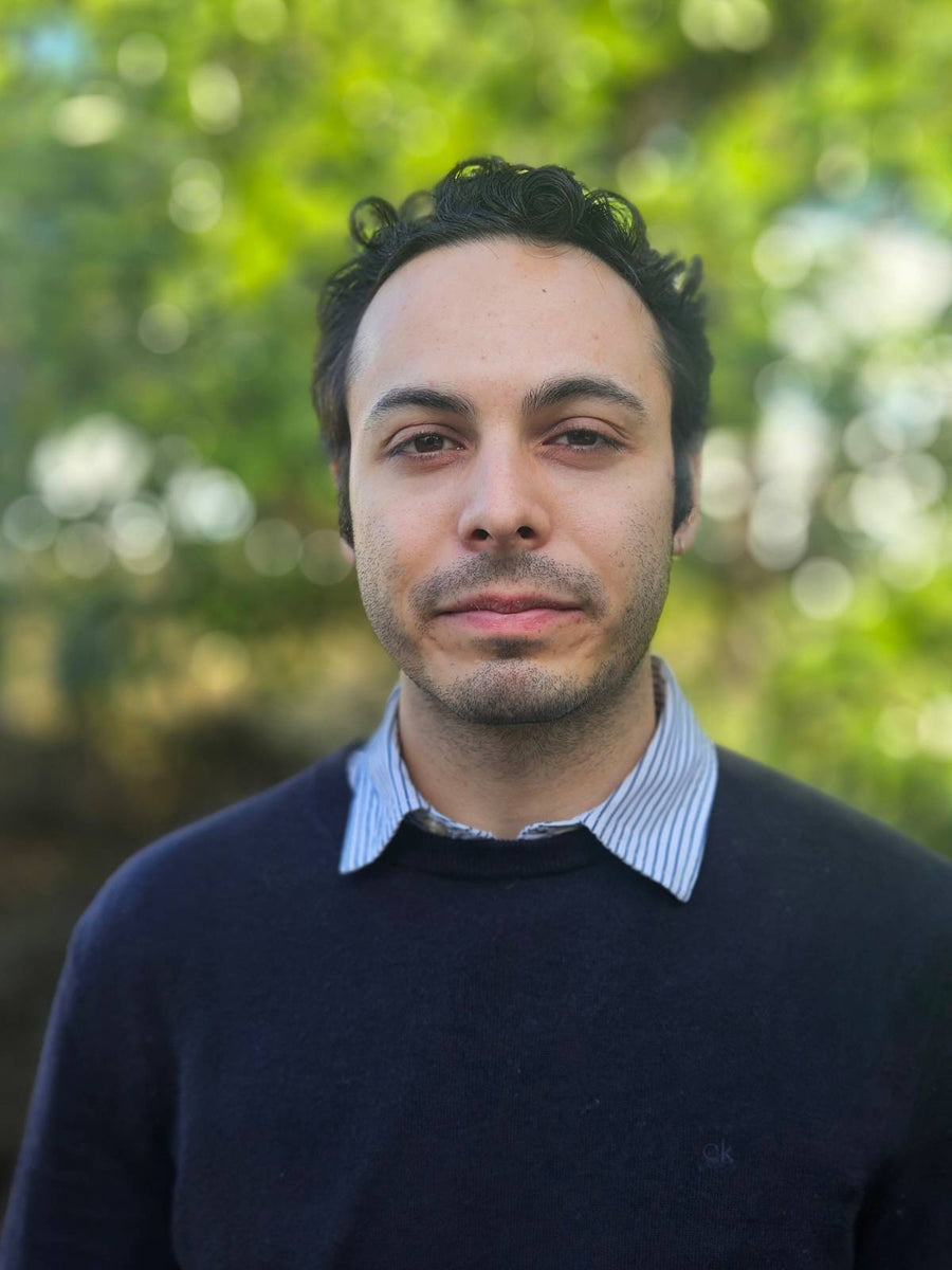 A portrait of a man with a green background