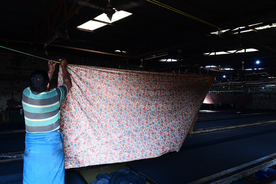 Large swaths of fabric are hung up to dry.