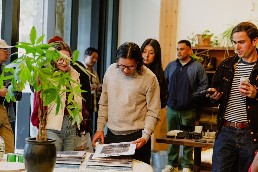 People standing at a table looking at records.