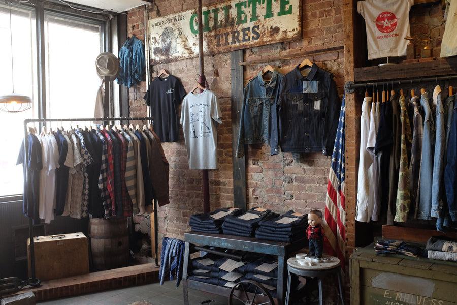 Inside view of shop. Clothes on display.