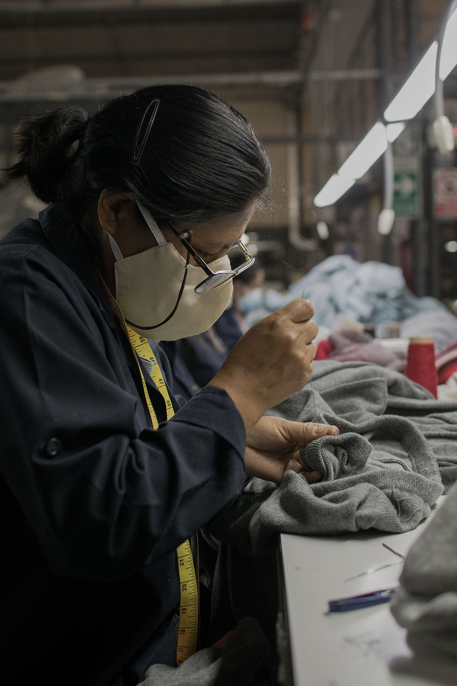 A lady sews a sweater.