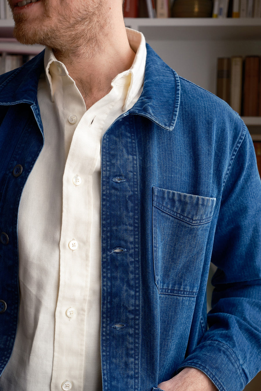 A close up image of a washed-down indigo herringbone jacket.