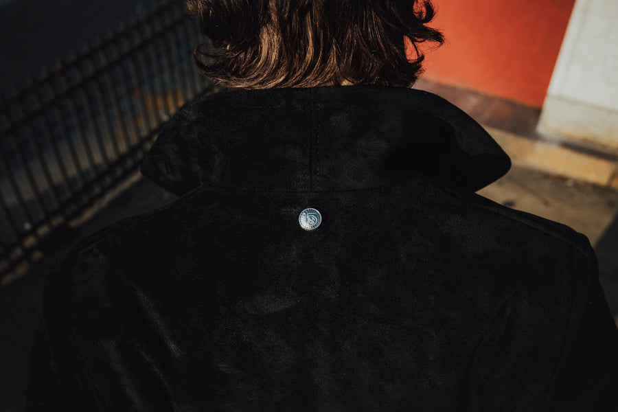 The back of the leather jacket features a sterling silver snap centered just below the collar.