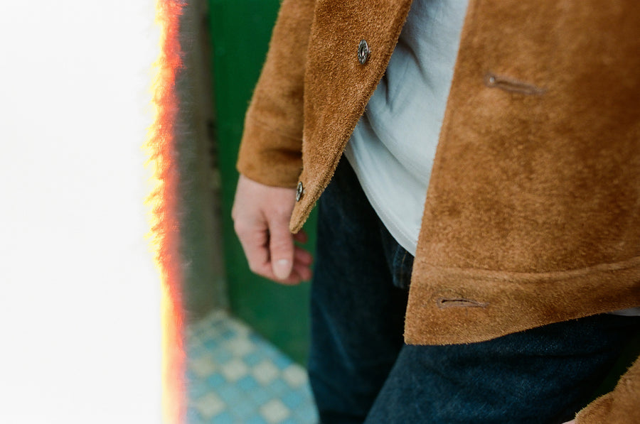 A close-up photo of a fuzzy suede leather jacket.