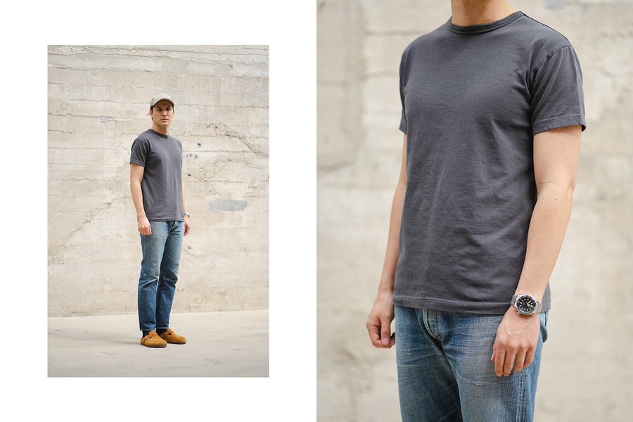A diptych of a man wearing the smoke tee with faded blue jeans.