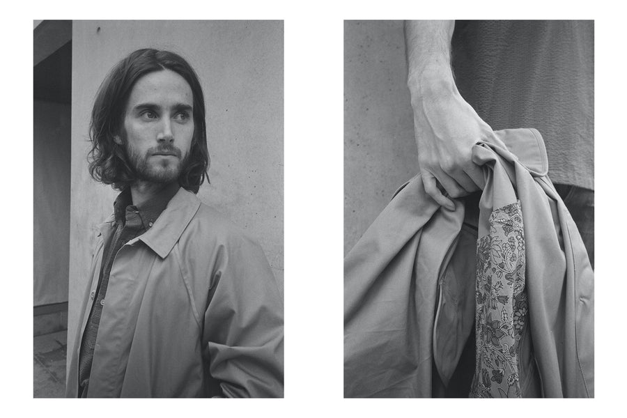 Two photos of a man in a light colored mac coat against a concrete wall.