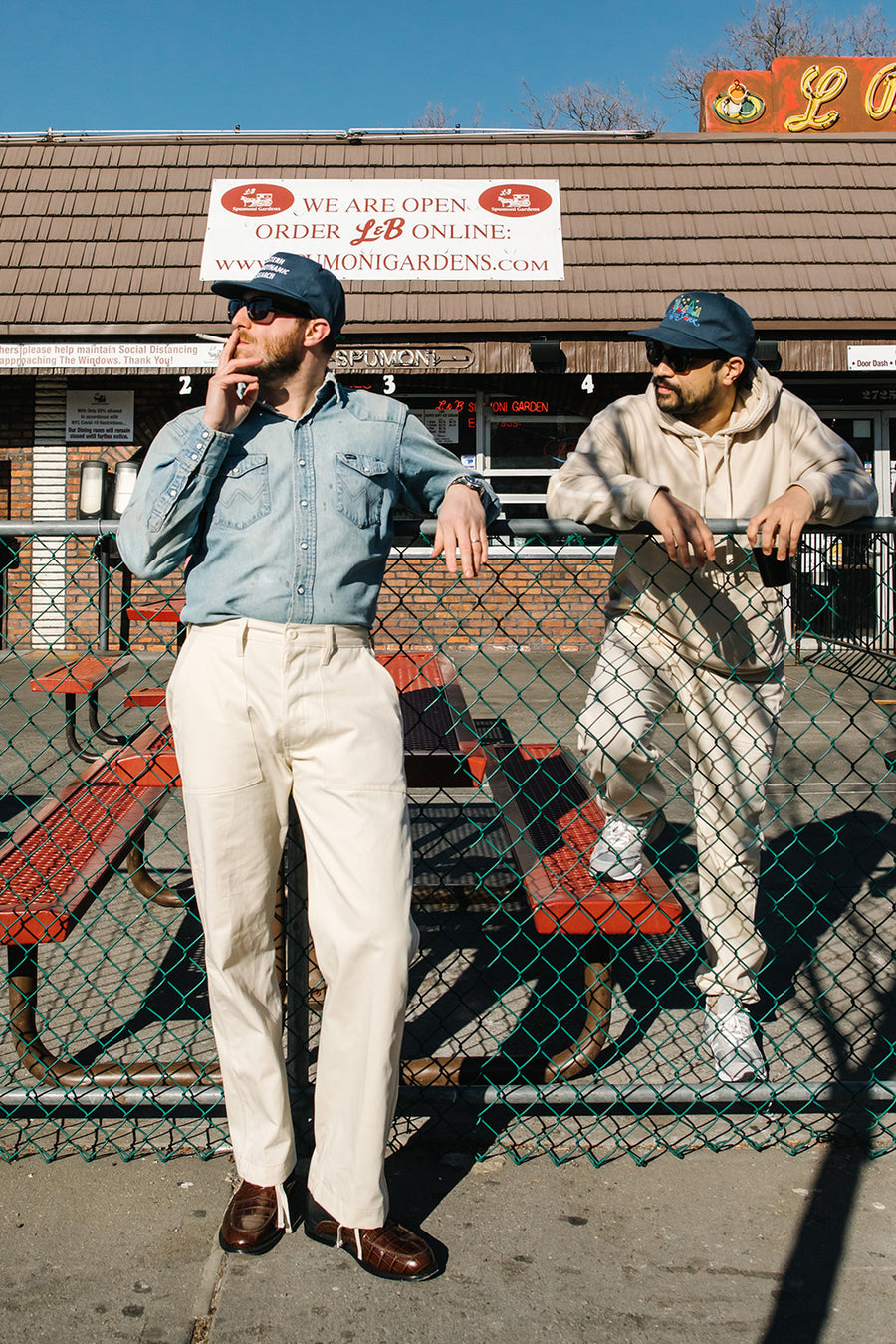 Two grown dirtbags stand outside L&B Spumoni Gardens.