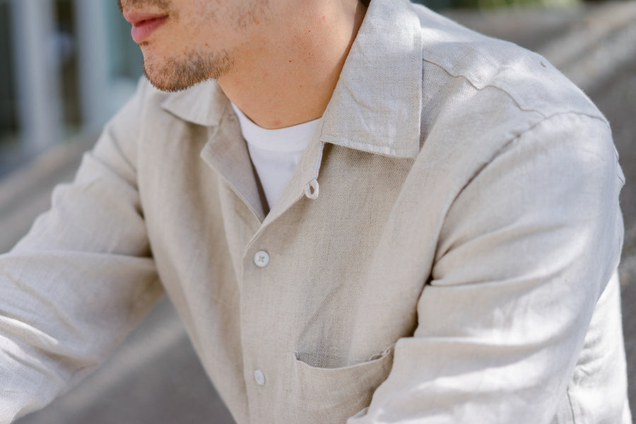 Up close shot of a tan linen shirt.