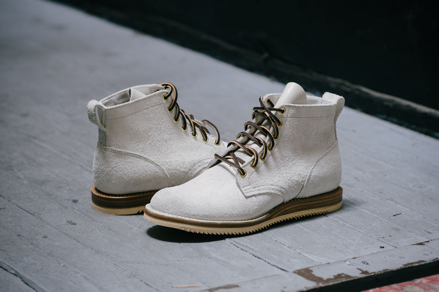 The backside of the white Viberg boots feature a heel pull tab.