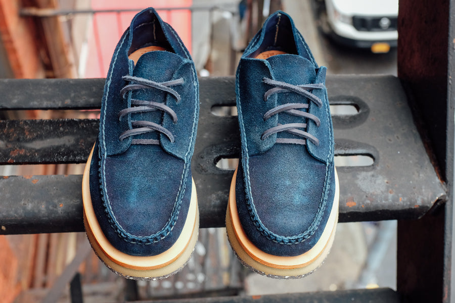 A top-down view of the indigo moccasins on the fire escape.