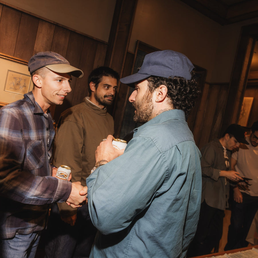 A group of guys chatting in a room.