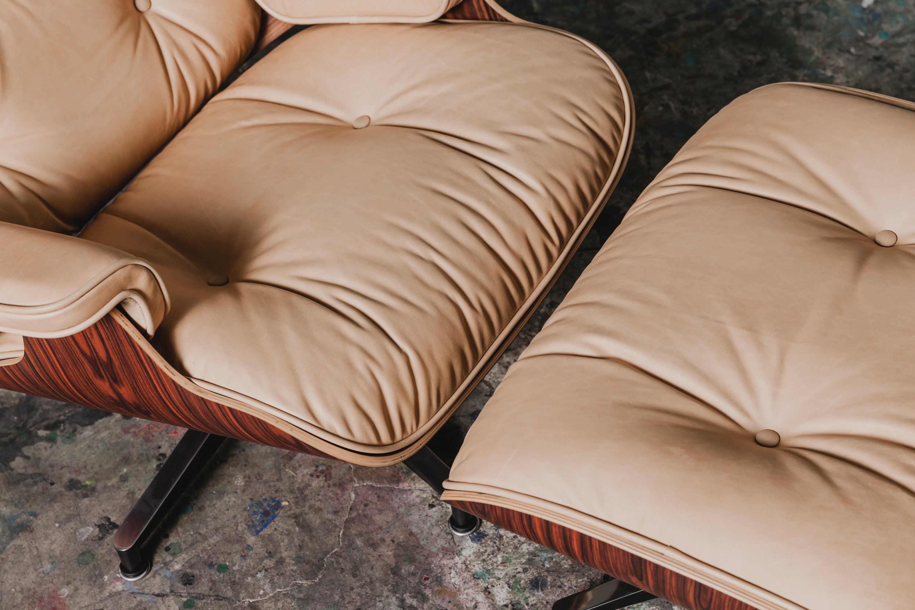 A close up shot of vegetable tanned leather upholstery on an Eames lounge chair.
