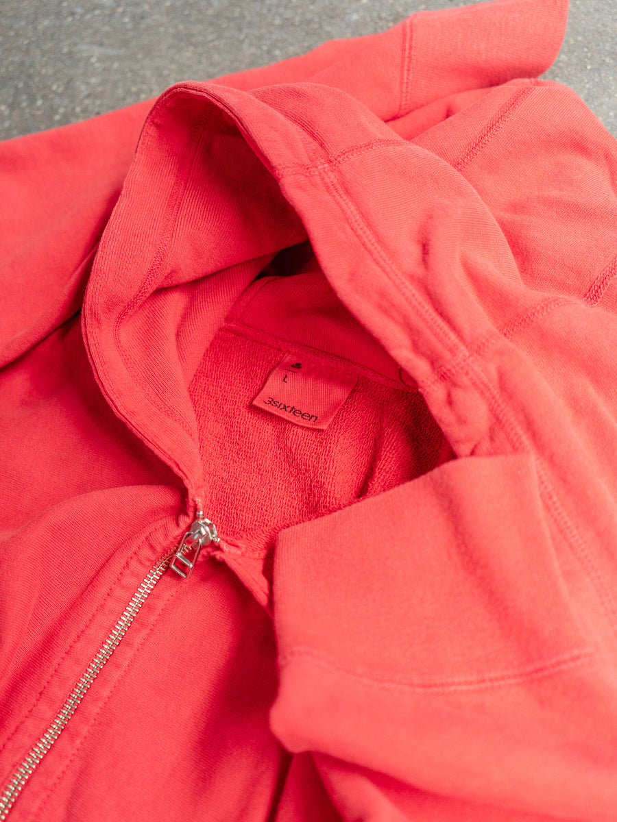 A close up shot of a red zip hoody.