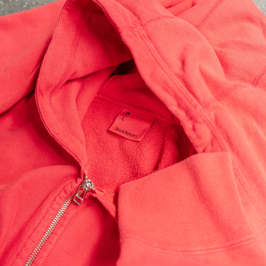 A close up shot of a red zip hoody.