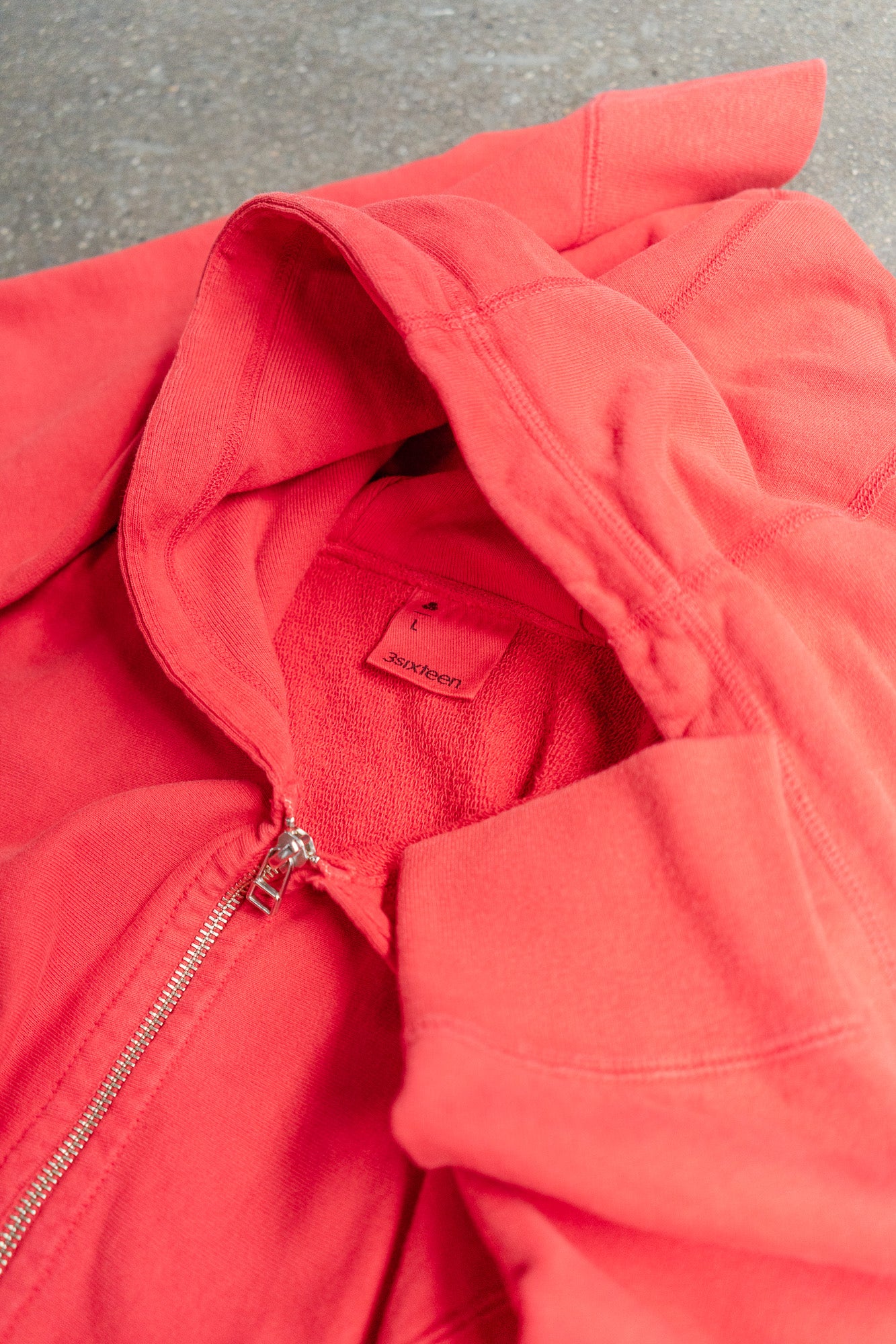 A close up shot of a red zip hoody.