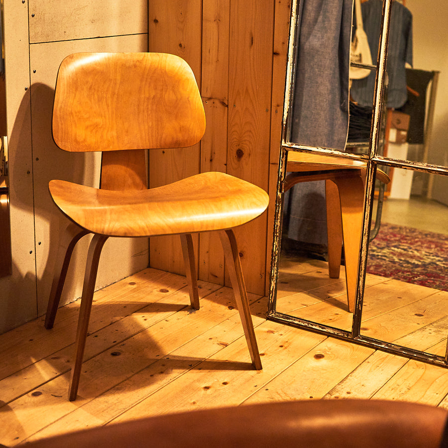 An eames chair in a mirrored dressing room.