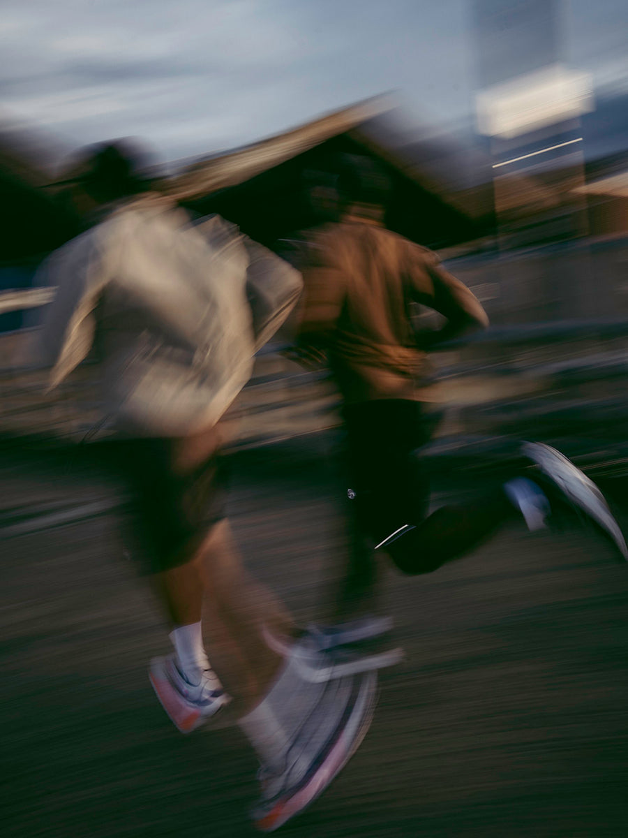 A speed blurred image of two men running.