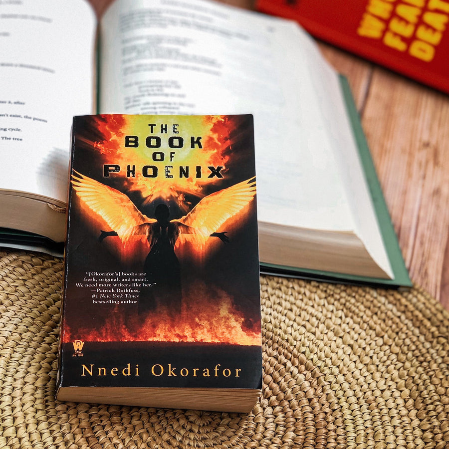 The Book of Phoenix softcover book laying on a table.