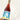A bottle of wine held up against a white background.